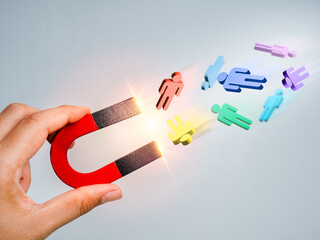 Business digital marketing, target audience, attract leads and customers concept. 3d human figure attracted by magnet in hand on grey background. Business team building, recruitment, hiring concepts.