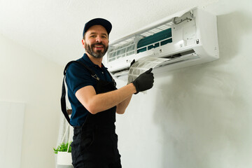 Hvac technician cleaning air conditioner filter during maintenance service