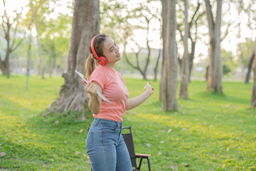 Woman uses iPad to listen to music outdoors