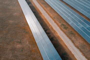 drone aerial view depicting sprawling solar farm panels glistening under sun in vast open terrain