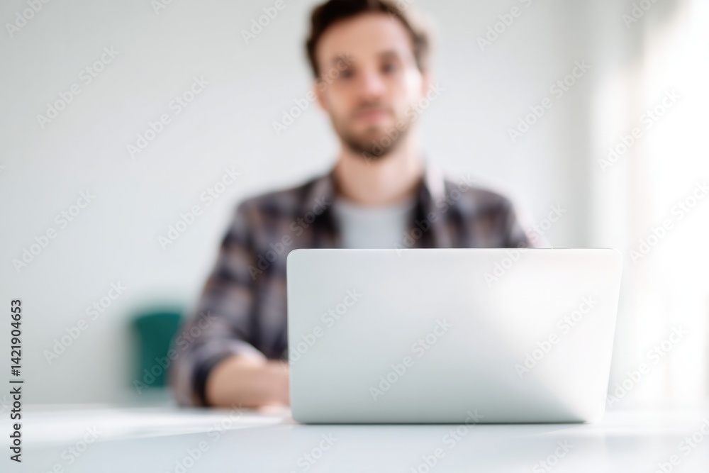 Poster front-facing portrait of individual working remotely at desk with laptop background intentionally bl