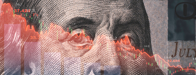 Red stock market graph chart on Benjamin Franklin face of USD dollar banknote for United States of...