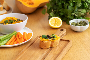 Bruschetta with pumpkin hummus and vegetables. Vegan snack, healthy food.