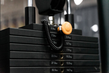 sstkWellness showcases the structure and precision of strength training through this image of a pin-loaded weight machine, designed for both safety and performance. This type of resistance equipment f