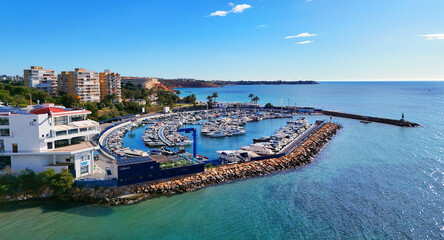Aerial stunning coastal view of Dehesa de Campoamor on Costa Blanca, Spain. Modern apartments,...