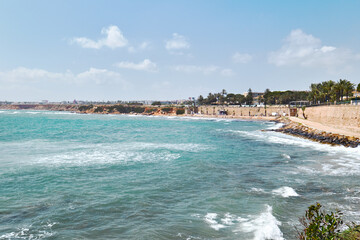 Fototapeta premium Scenic coastline of Punta Prima, turquoise waters of Mediterranean Sea, rocky cliffs along shoreline. Costa Blanca, Province of Alicante, Spain