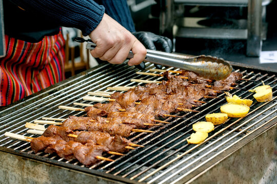 Cooking Meat Skewers On BBQ Grill