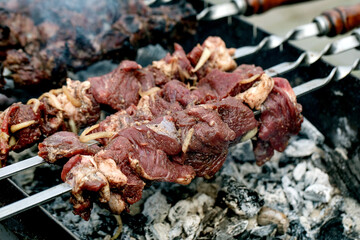 Raw Meat Skewers Cooking Over Charcoal