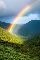 Vibrant rainbow arcs over lush green valley under dramatic sky