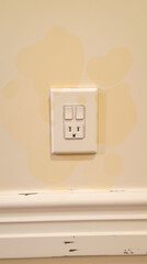 white electrical outlet and double on a textured wall