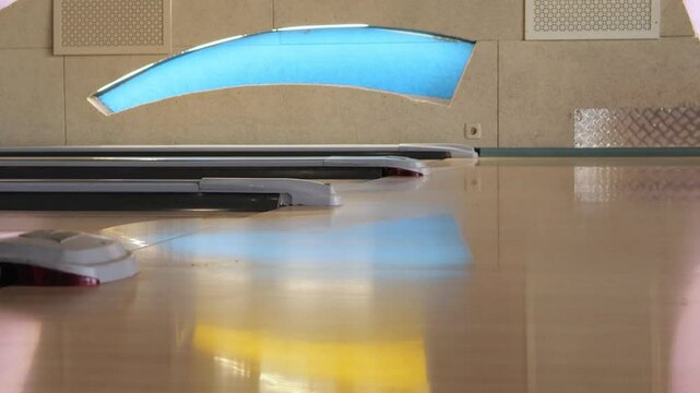 Lanes shine brightly under colorful lights as bowlers prepare to roll strikes during an energetic night at the local bowling alley