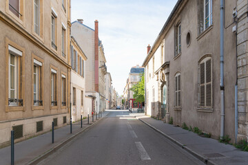 Quiet street in Nancy, France, known as Rue du Manège, with old stone buildings, soft shadows, and a peaceful urban atmosphere.