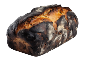A tragically charred loaf of bread, once golden and promising, now bears the marks of a baking mishap, a somber testament to culinary misfortune against a stark white background.