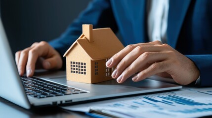 Fototapeta premium Professional analyzing property loan trends in office environment business report with model house