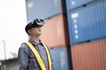 Asia worker man use VR headset working with checking container at container site	