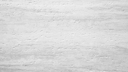 Fototapeta premium A white abstract background with a grey rough texture. wall is made of stone and has a lot of cracks and holes. texture of wall is uneven and rough, giving it a somewhat aged and worn appearance