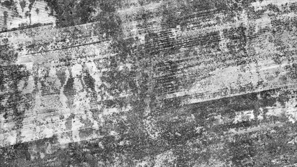 Gray wall with many cracks holes scratches and marks. wall is made of concrete and has a rough texture as an abstract texture background for template pages and banners.