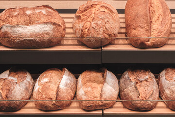  display of bread with a variety of shapes and sizes. The bread is arranged on shelves and is ready...