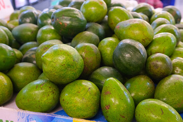 Fresh Green Avocados in Market Display, Abundant Harvest