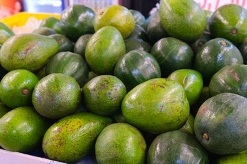 Vibrant Green Avocados in a Bountiful Market Display