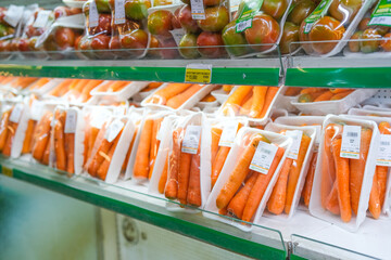 Grocery Store Shelf: Packaged Carrots and Apples
