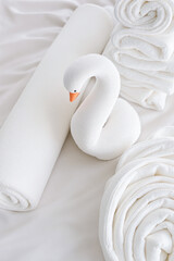 Obraz premium soft white towels and blankets arranged with a plush swan creating a serene and peaceful atmosphere