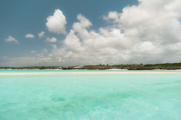 Turquoise water lapping on white sand beach in mnemba atoll, zanzibar