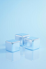 three pale-blue metallic cubes on a reflective surface