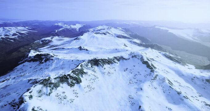 Majestic mountain range covered in snow stretches across the horizon. The bright day reveals the stunning slopes and valleys, reflecting tranquility and natural beauty in winter.