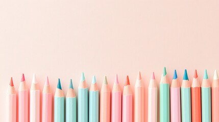 Colorful Pastel Colored Pencils on Soft Pink Background