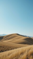 Fototapeta premium Serene Landscape of Rolling Hills Under Clear Blue Sky