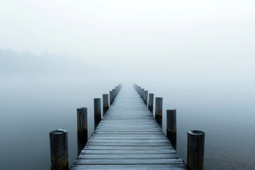 Fototapeta premium Serene lake with a misty wooden dock.