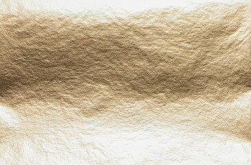 Gold leaf gilding on a luxurious, antique background. Elegant, royal texture with a shiny, delicate finish. The warm, metallic surface shimmers, creating a vintage, refined design. Decorative material