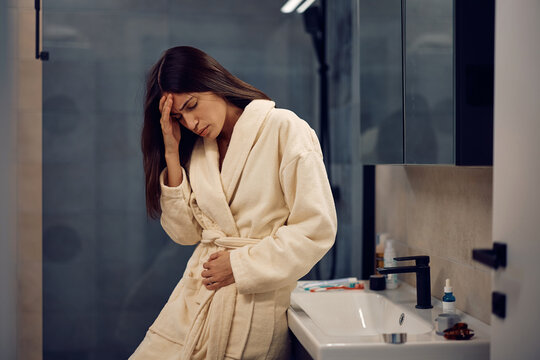 Young woman feeling nauseous in morning.