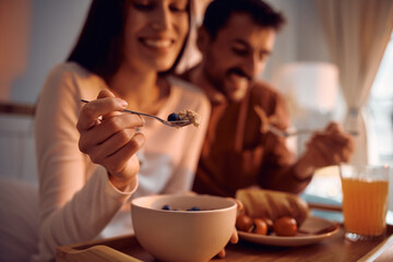 Close up of couple having breakfast in bed.
