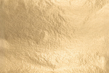 Obraz premium Gold metallic foil texture with a smooth, soft surface. Shiny, glowing design in a rich yellow tone, creating an elegant, premium effect. Refined, minimal pattern with subtle shimmer and a clean,.