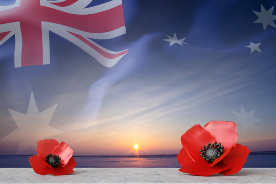 Red poppy flowers laying on a stone desk against the sunset with Australis flag. Remembrance Day, Anzac Day concept