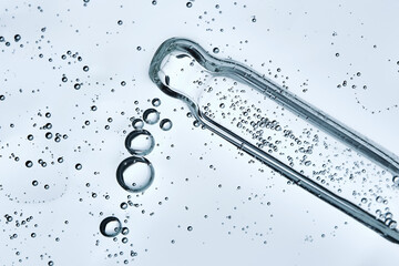 The texture of a serum or cosmetic gel with a pipette. Angle from below.