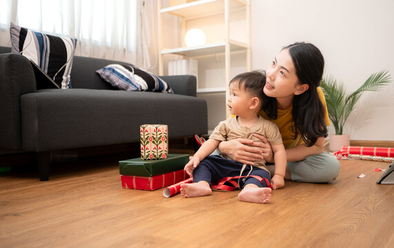 While in vacation at home, a mother gift wrap with little kid