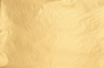 Golden foil sheet with warm, soft yellow glow. Glistering, pearlescent finish and subtle reflective...