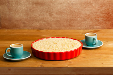 Homemade pie with streisel and two cups of coffee espresso on wooden table.