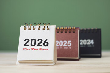 Calendar page of 2026, white on wooden table. Concepts of planning for success, setting goals, planning strategies, and taking action steps.