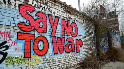 say no to war graffiti appears on a wall
