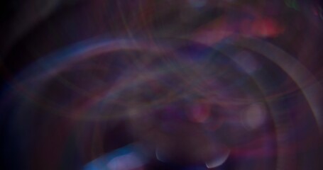 Colorful art flare. Defocused shine round. Blue neon bright sparkling particles motion on dark black blurred abstract bokeh light background.