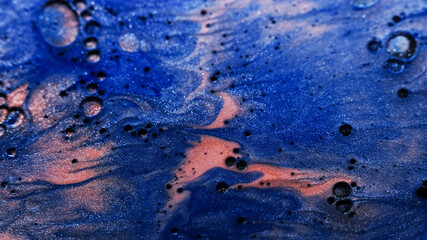 Ink mix flow. Glitter fluid spill. Defocused blue bronze color paint in water oil bubbles spreading on abstract marble background.
