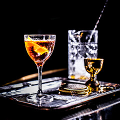 Cocktail with bar tools on dark background