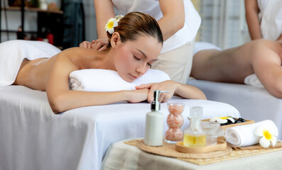 Caucasian couple customer enjoying relaxing anti-stress spa massage and pampering with beauty skin...