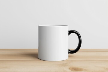 Obraz premium A white coffee mug with a black handle sits on a wooden table. The mug is empty and has a clean, minimalist design. The contrast between the white and black colors creates a modern