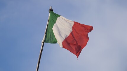 Italian national flag waving against clear blue sky