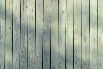 peeling green wooden fence boards